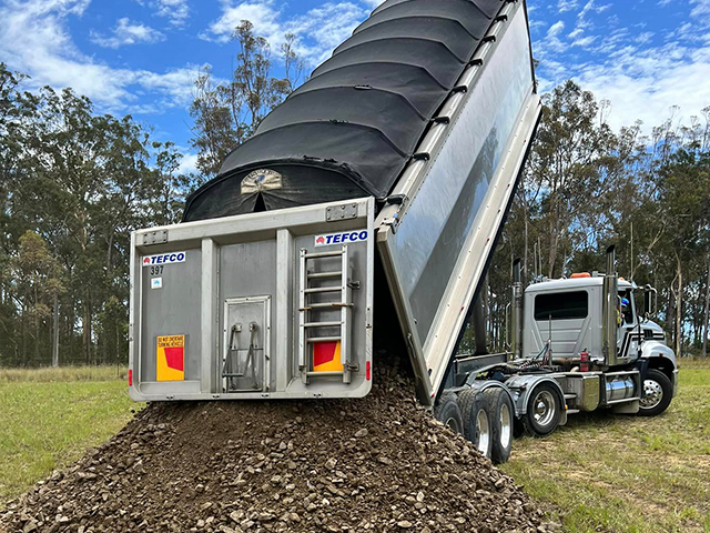 Large truck dropping off materials